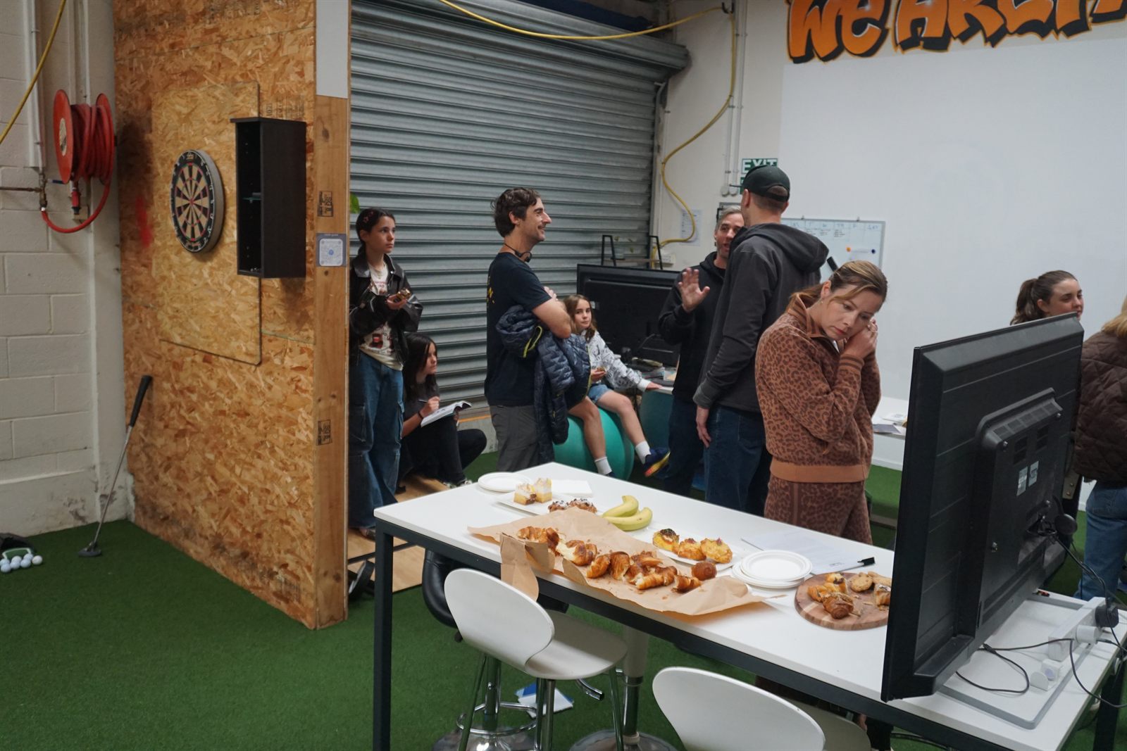 People hanging out near darts and kai at Node Space